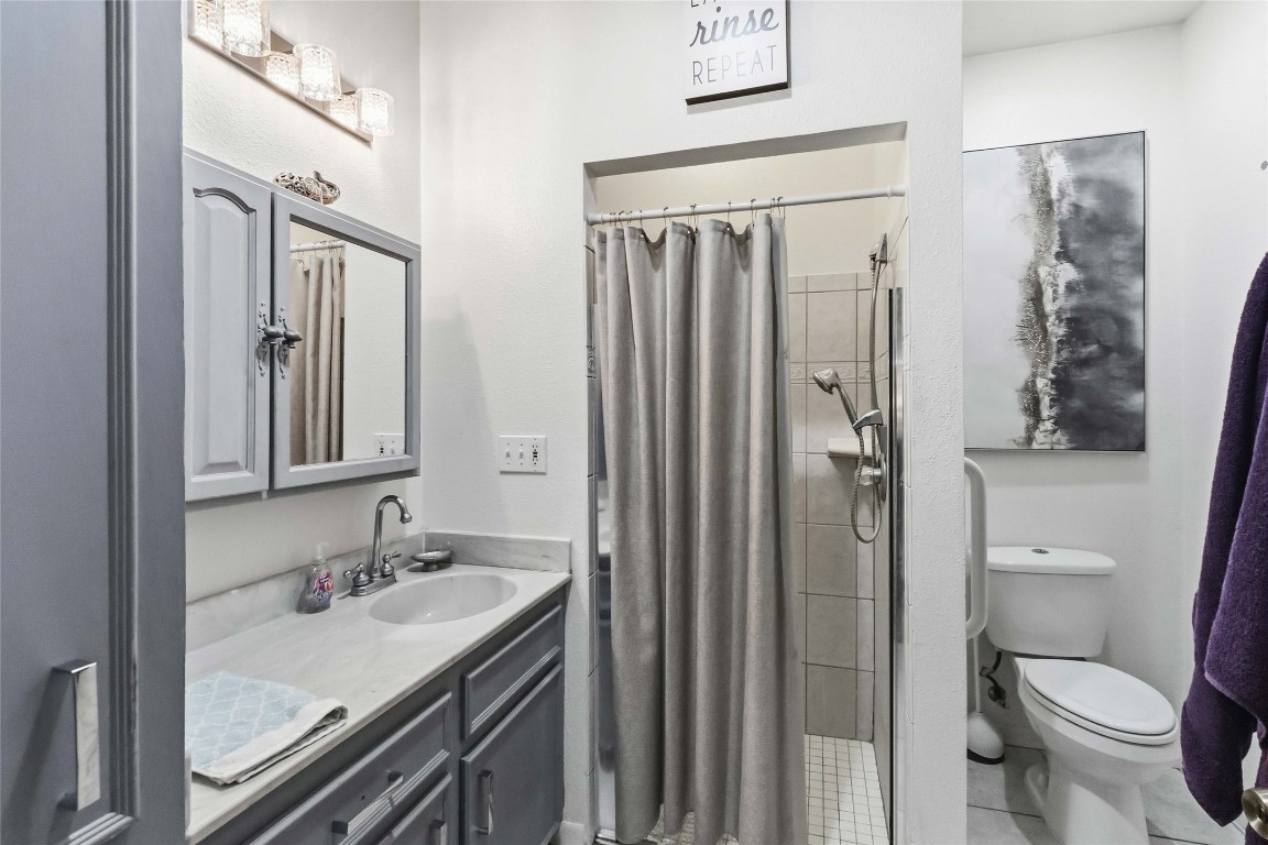 581 State Highway 95 Elgin, TX 78621 - Photo 14 of 30 a bathroom with a granite countertop sink toilet and shower
