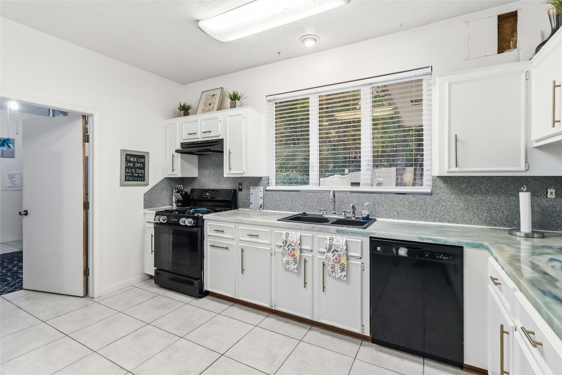 581 State Highway 95 Elgin, TX 78621 - Photo 19 of 30 a kitchen with stainless steel appliances granite countertop a stove a sink and a refrigerator