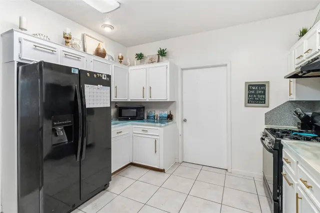a kitchen with stainless steel appliances granite countertop a sink and cabinets