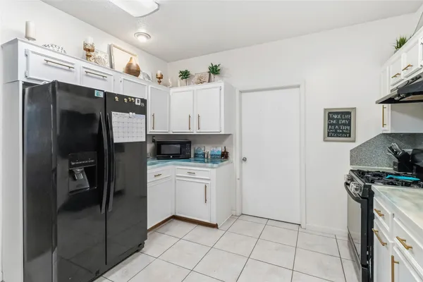 a kitchen with stainless steel appliances a refrigerator sink and cabinets