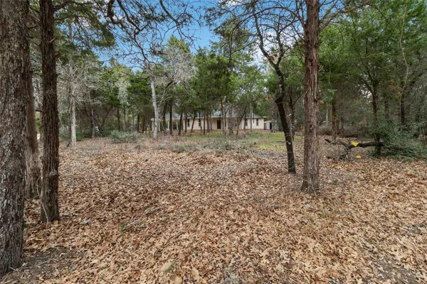 a backyard of a house with lots of green space