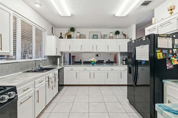 a kitchen with stainless steel appliances granite countertop a sink and cabinets