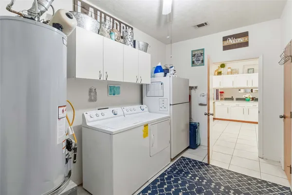 a kitchen with a refrigerator a stove and cabinets