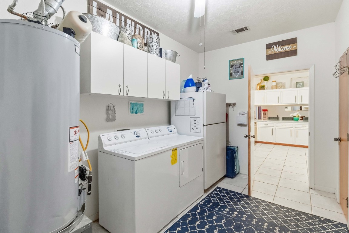 581 State Highway 95 Elgin, TX 78621 - Photo 22 of 30 a kitchen with a refrigerator a stove and cabinets