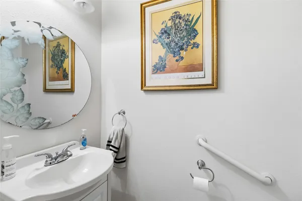 a bathroom with a sink mirror and vanity