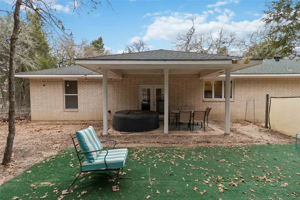 a view of house with backyard and seating space