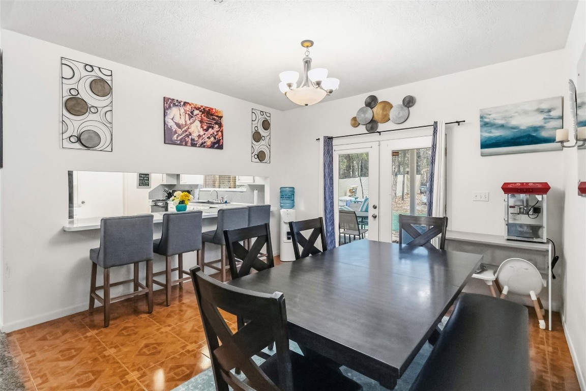 581 State Highway 95 Elgin, TX 78621 - Photo 9 of 30 a view of a dining room with furniture and chandelier