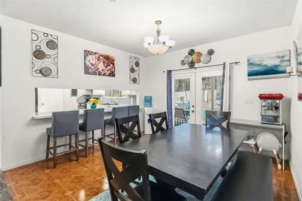 a view of a dining room with furniture and chandelier