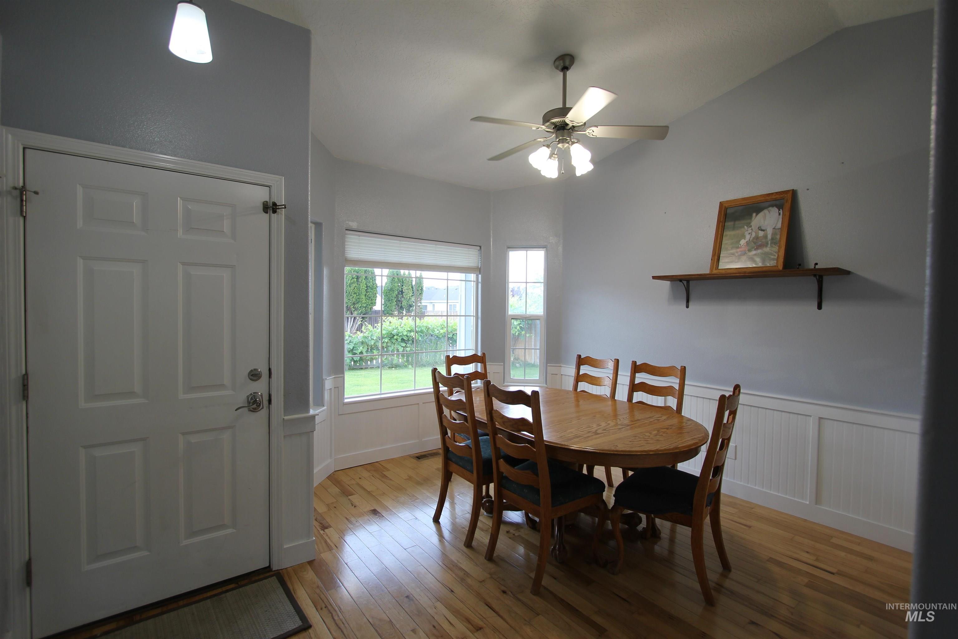4816 Kadie Street Caldwell, ID 83607 - Photo 7 of 23 Light wood-finish flooring complements the wainscoting and light gray walls