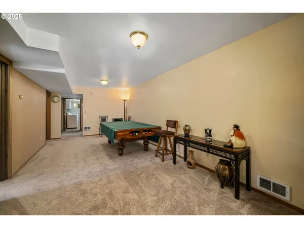 a living room with furniture and a piano