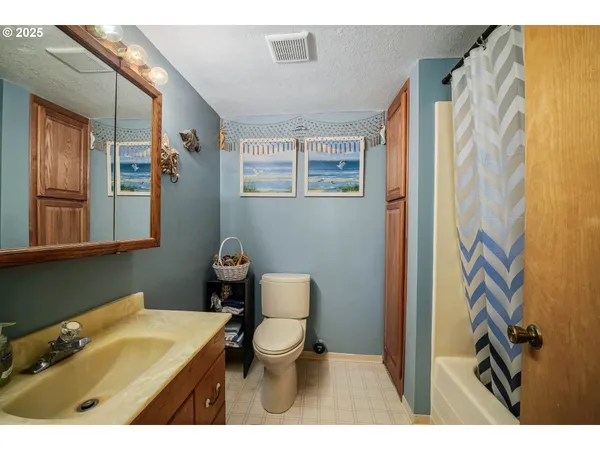 a bathroom with a sink toilet and mirror