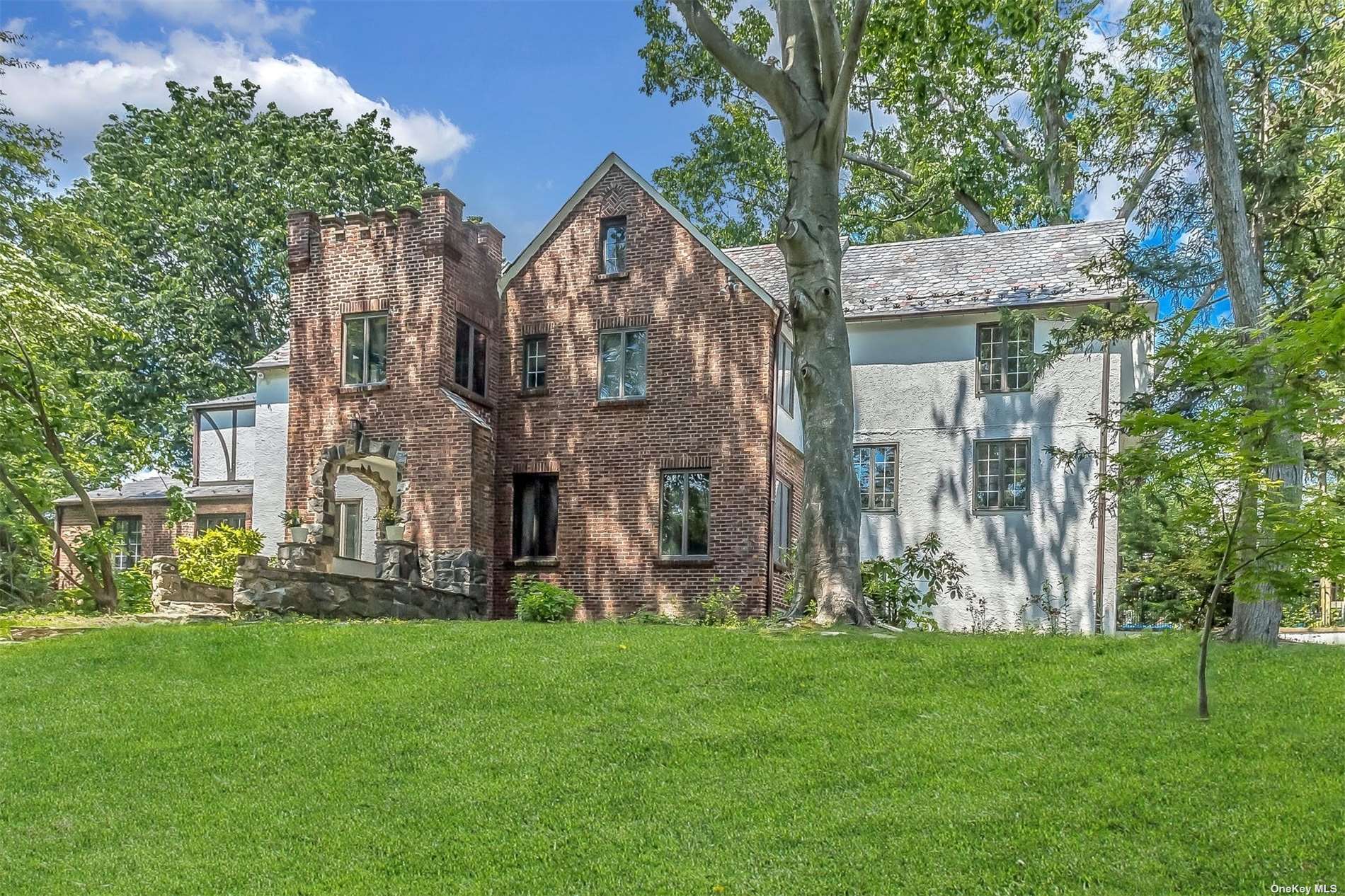 3 Tulip Drive Great Neck, NY 11021 - Photo 1 of 1 a view of a big yard in front of a brick house with large windows