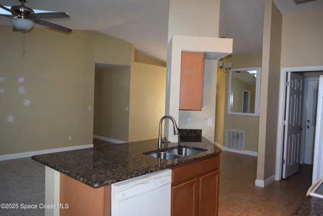 a bathroom with a shower and a white door