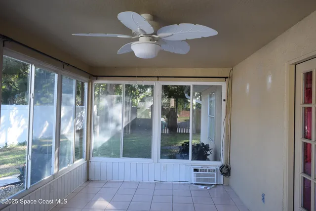 an empty room with windows and cabinet