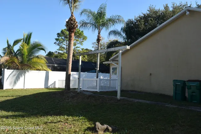 a view of a house with wooden fence