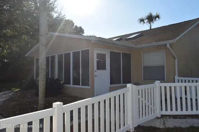 an empty room with stairs and wooden floor