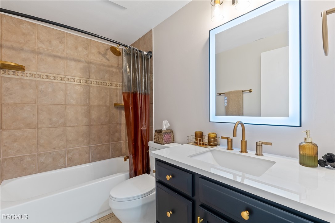 170 5th Street South Naples, FL 34113 - Photo 14 of 23 a bathroom with a granite countertop sink a toilet and shower