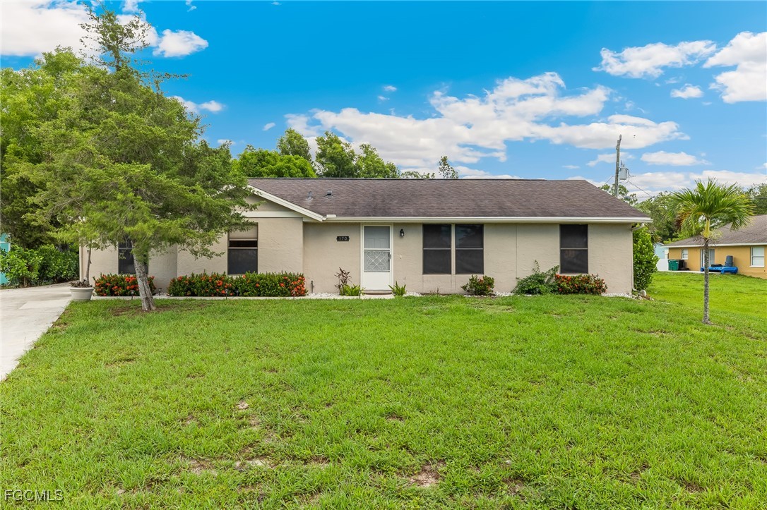 170 5th Street South Naples, FL 34113 - Photo 2 of 23 a front view of a house with a yard