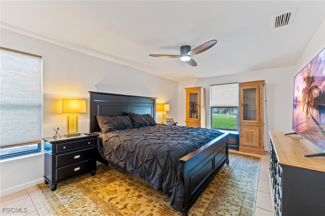 170 5th Street South Naples, FL 34113 - Photo 10 of 23 a bedroom with a bed a dresser and a flat screen tv
