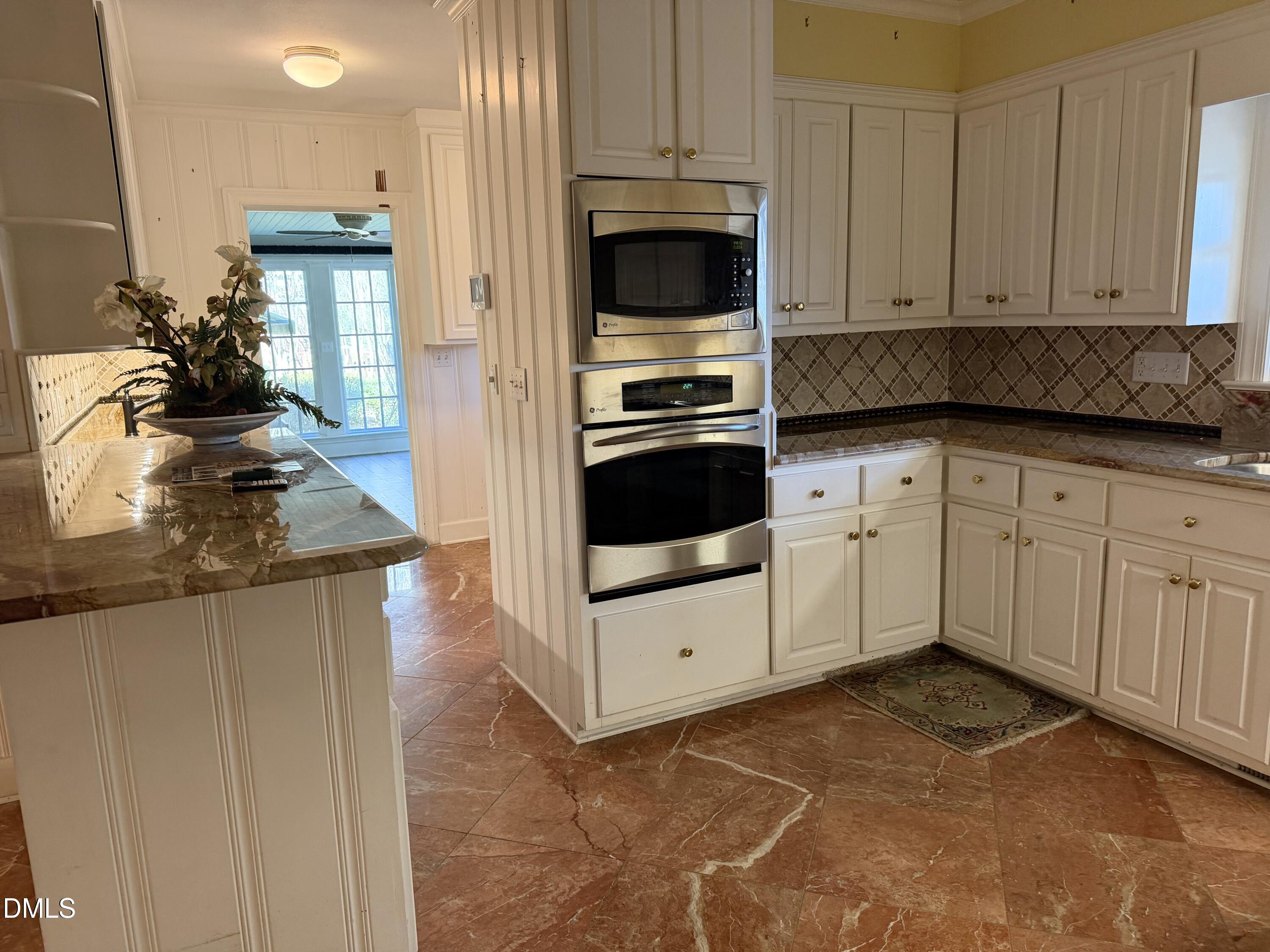 173 Park Circle Faison, NC 28341 - Photo 19 of 56 a kitchen with granite countertop white cabinets and stainless steel appliances