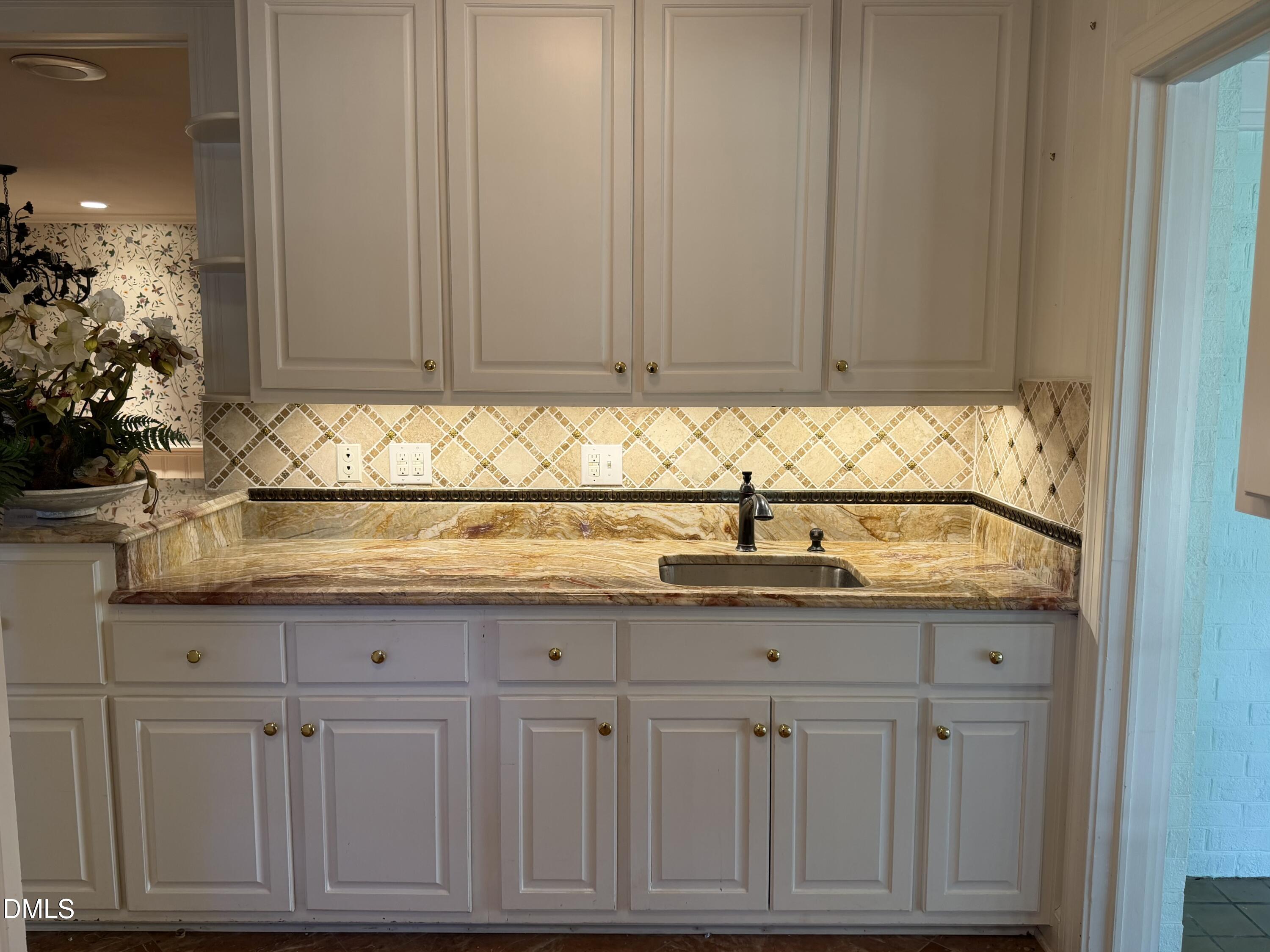 173 Park Circle Faison, NC 28341 - Photo 20 of 56 a kitchen with granite countertop a sink and cabinets