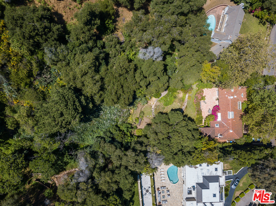 1491 Stone Canyon Road Los Angeles, CA 90077 - Photo 26 of 27 an aerial view of residential house with outdoor space and trees all around