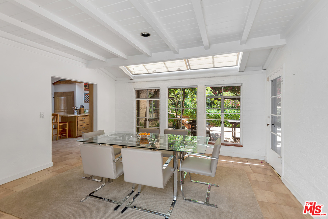 1491 Stone Canyon Road Los Angeles, CA 90077 - Photo 4 of 27 a dining room with furniture and window