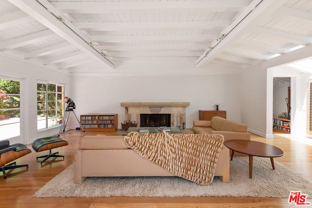 1491 Stone Canyon Road Los Angeles, CA 90077 - Photo 9 of 27 a living room with furniture and a fireplace
