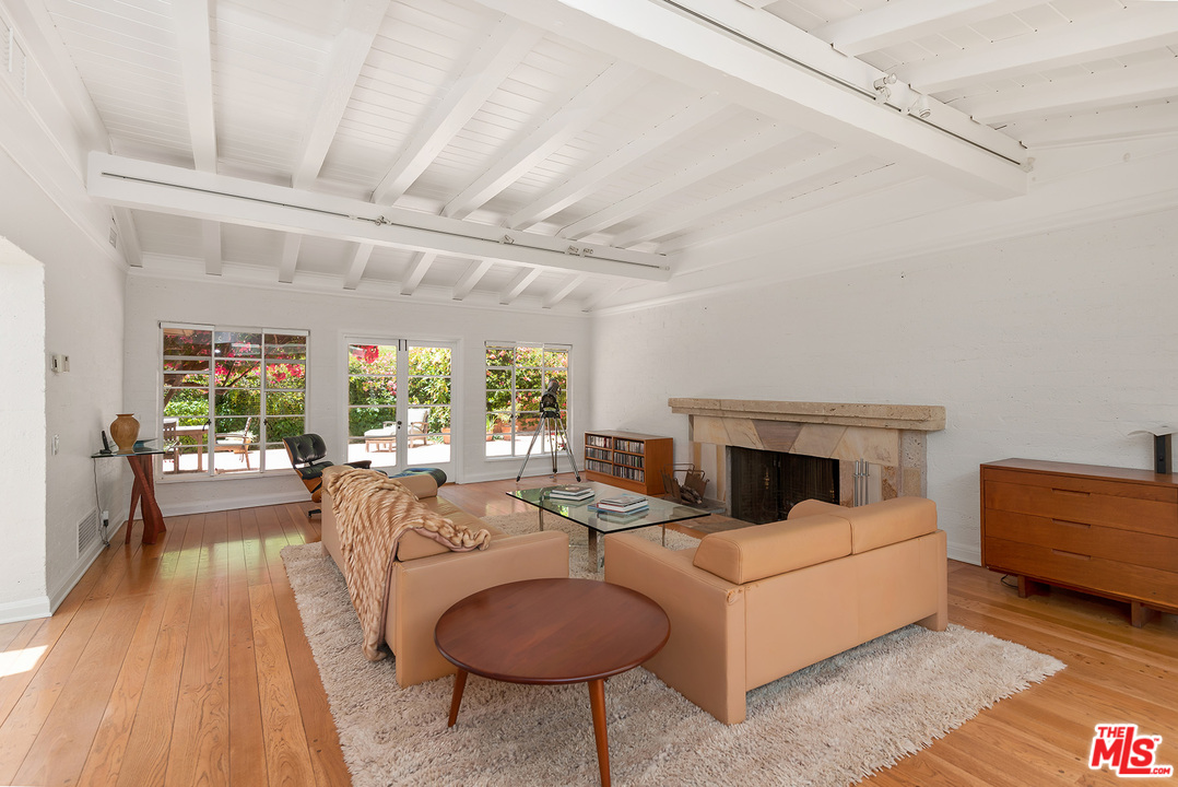 1491 Stone Canyon Road Los Angeles, CA 90077 - Photo 10 of 27 a living room with furniture and a fireplace