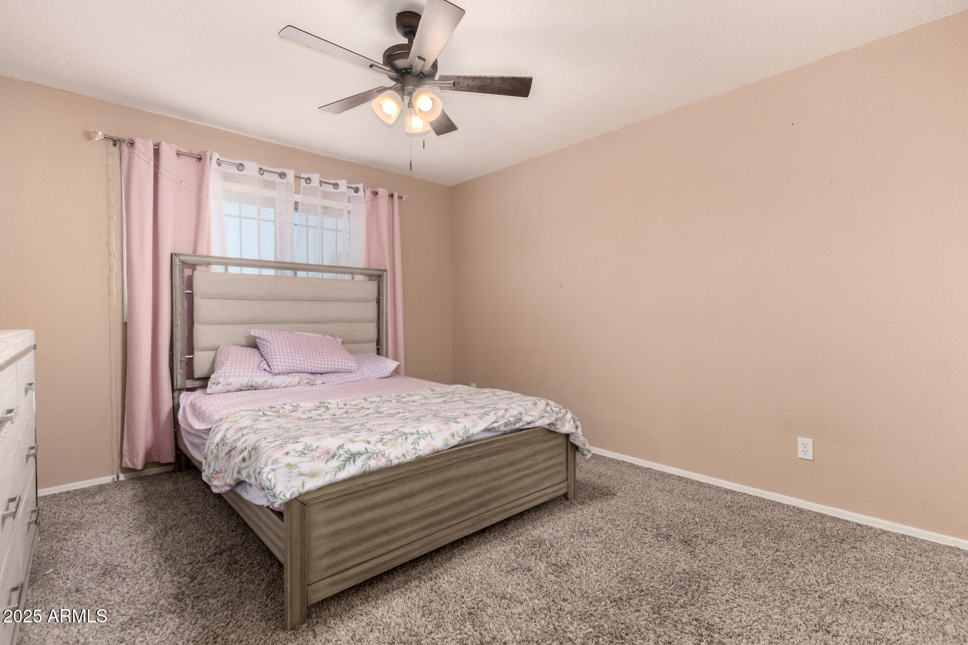 3529 West St Moritz Lane Phoenix, AZ 85053 - Photo 23 of 34 a bedroom with a bed and a chandelier