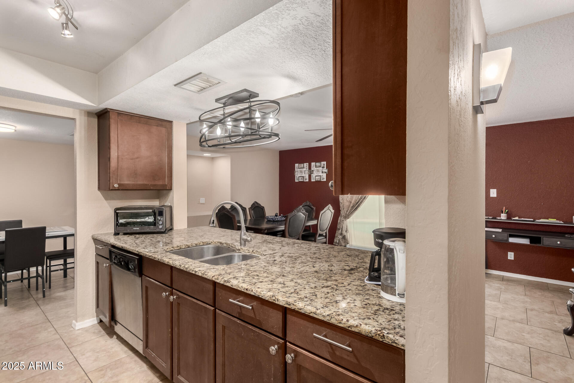 3529 West St Moritz Lane Phoenix, AZ 85053 - Photo 8 of 34 a kitchen with kitchen island granite countertop a sink counter and chairs