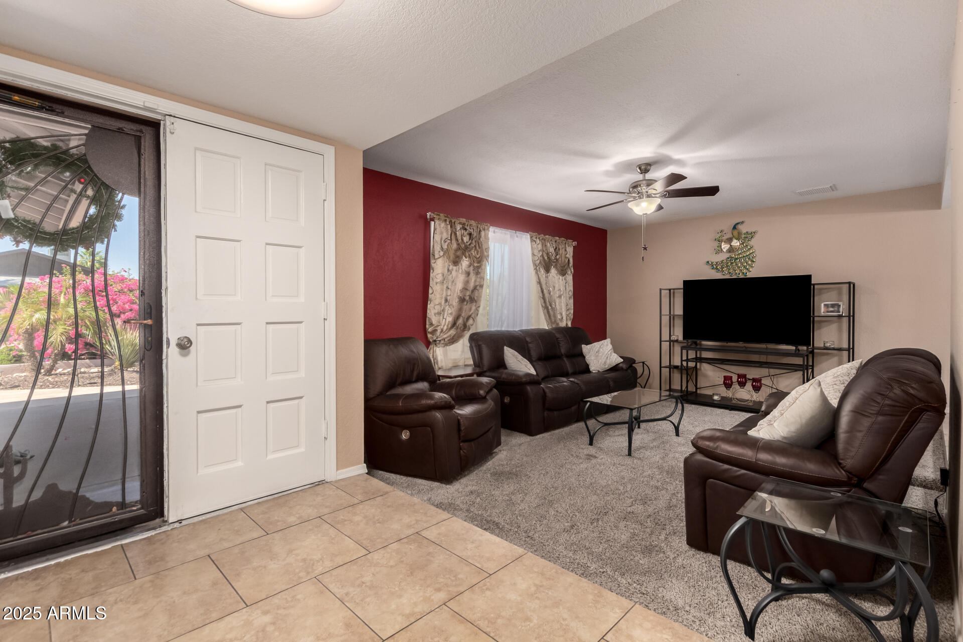 3529 West St Moritz Lane Phoenix, AZ 85053 - Photo 10 of 34 a living room with furniture a flat screen tv and a window