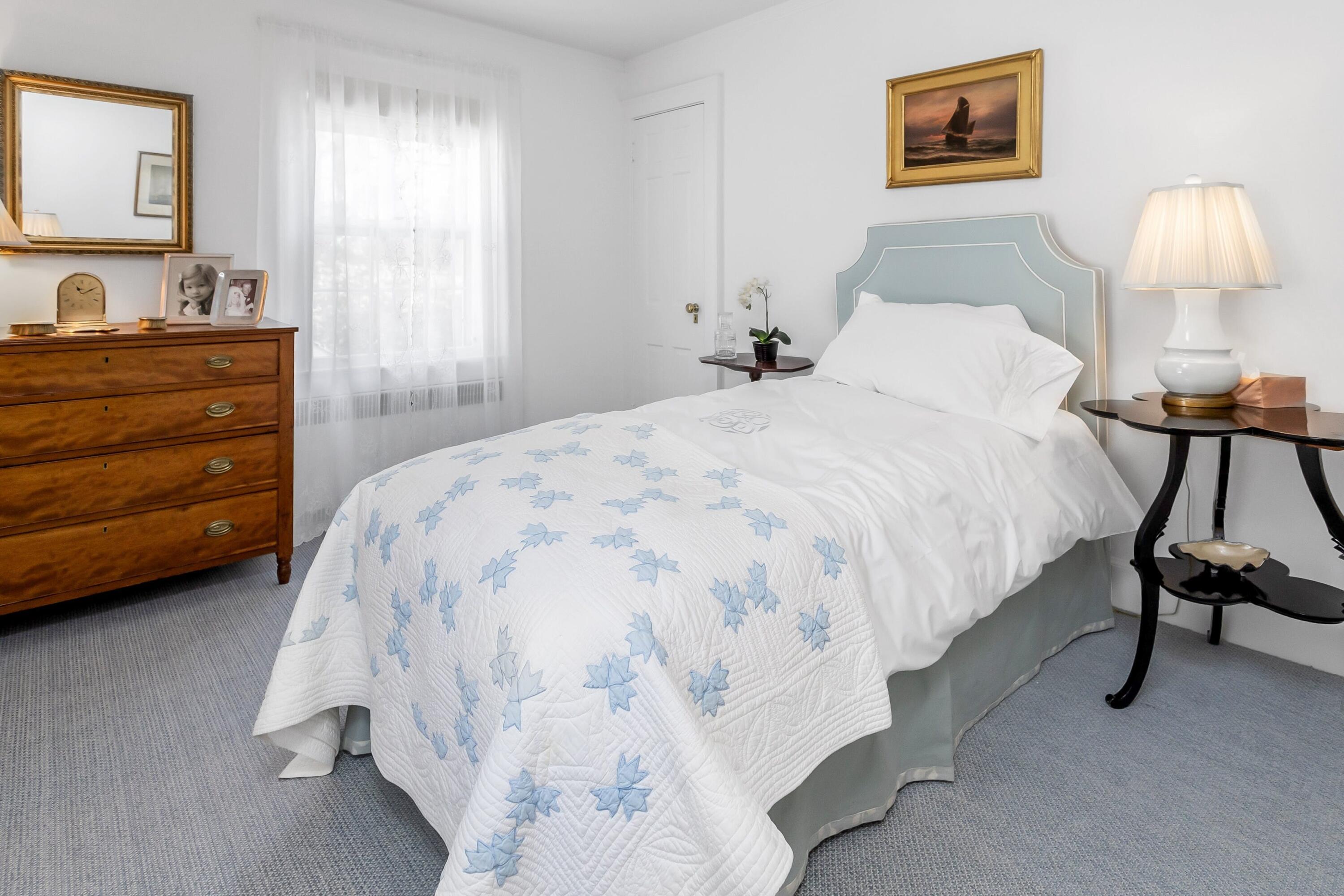 40 Birch Road Darien, CT 06820 - Photo 16 of 27 a bedroom with a bed and a lamp on dresser