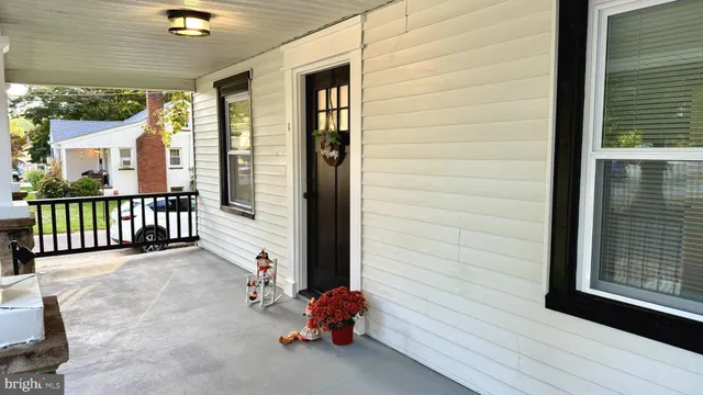 a view of a porch with a table and chairs
