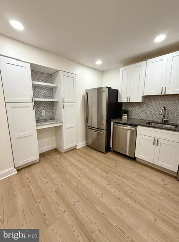 a view of a kitchen with a sink refrigerator and a cabinets