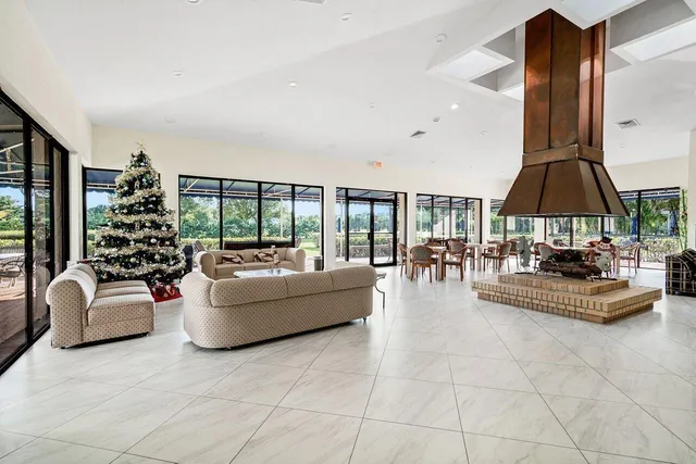 a dining room with furniture and large windows