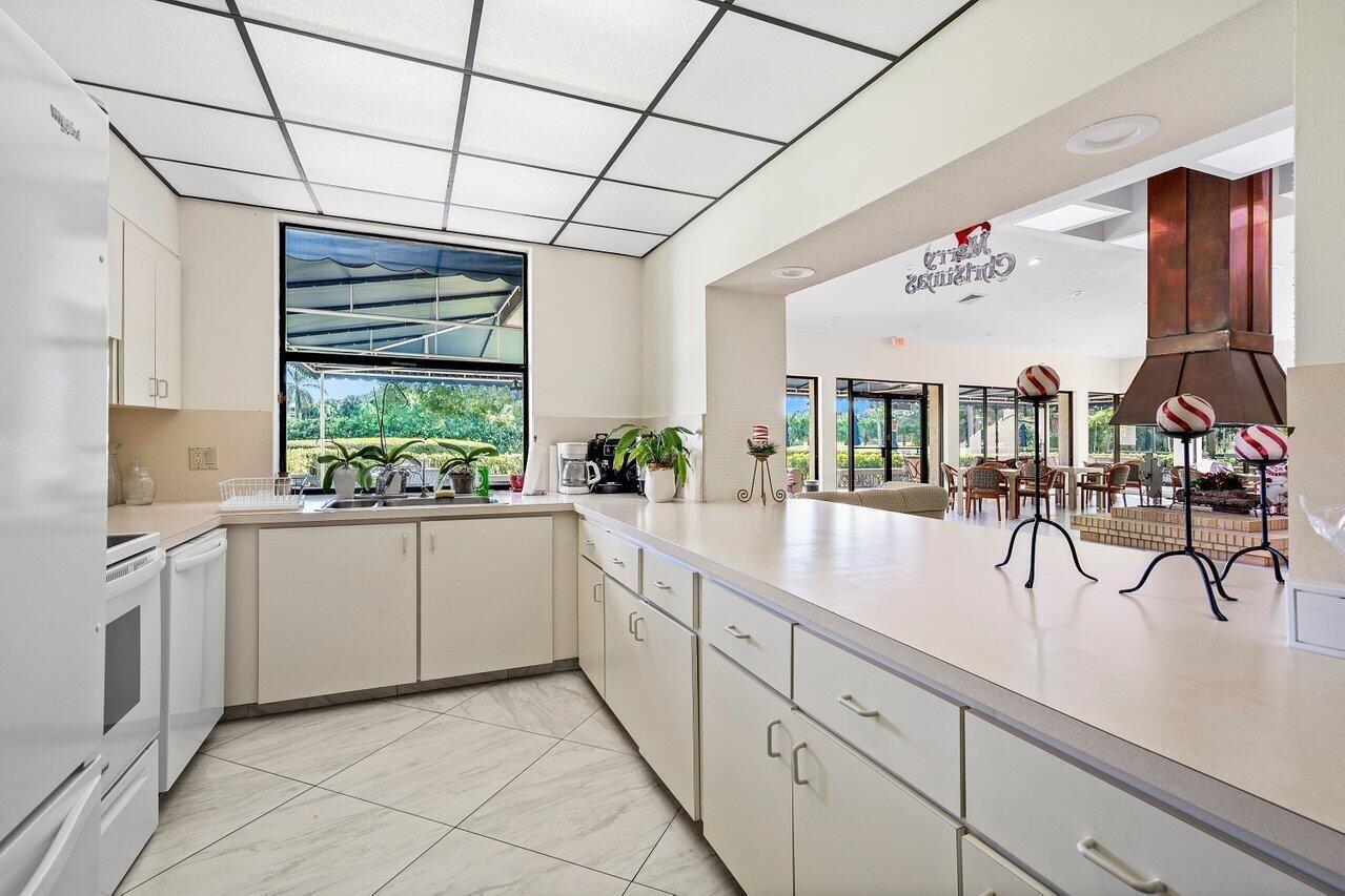 6420 Boca Del Mar Drive, Unit 308 Boca Raton, FL 33433 - Photo 32 of 37 a kitchen with stainless steel appliances sink and cabinets