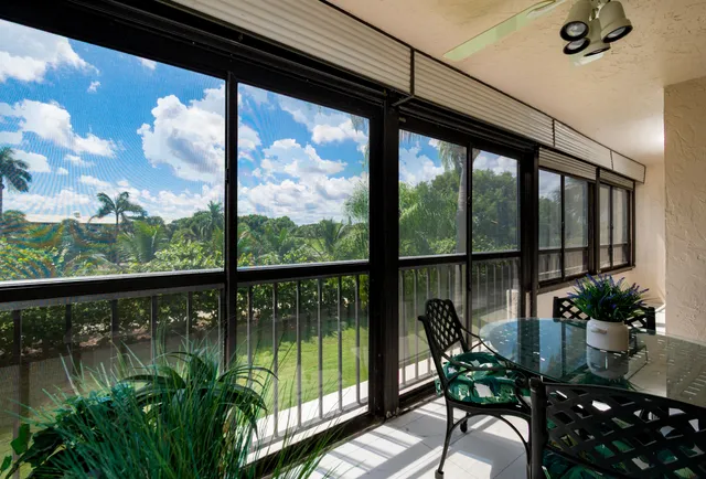 a view of a chairs and table in patio of a balcony