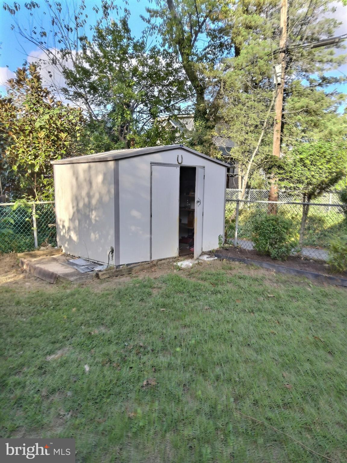 2040 31st Place Southeast Washington, DC 20020 - Photo 19 of 24 Charming garden shed nestled in greenery.