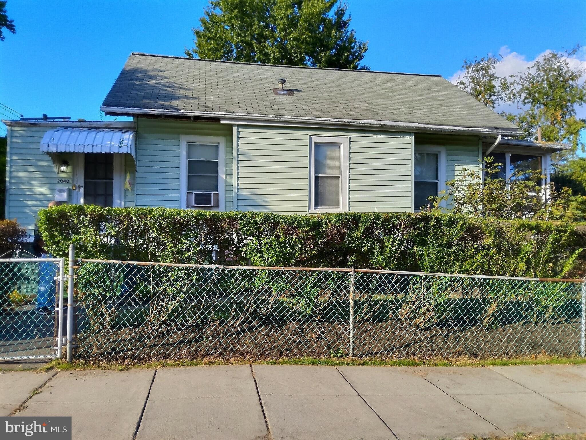 2040 31st Place Southeast Washington, DC 20020 - Photo 2 of 24 Charming green home with lush hedges.