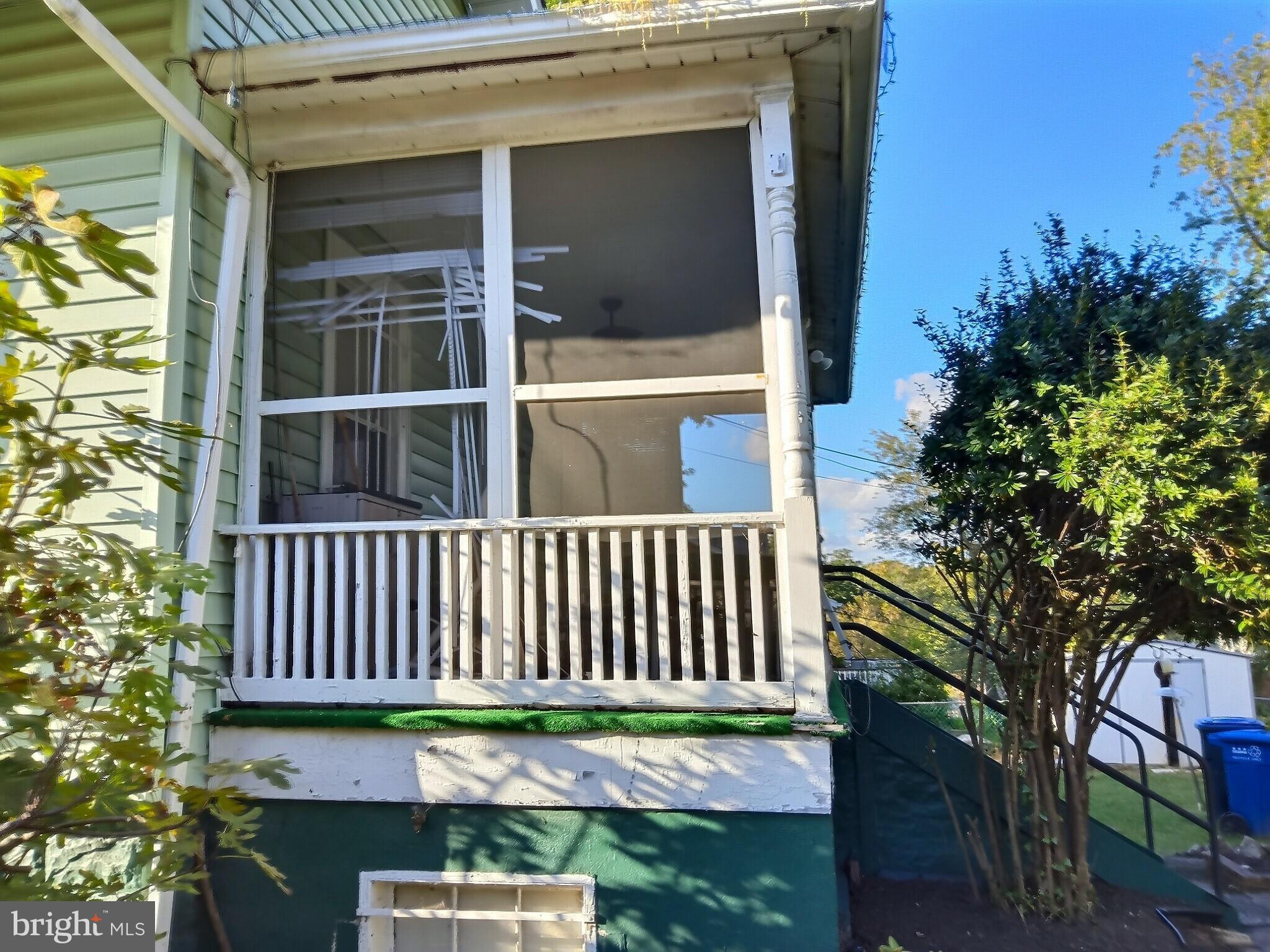 2040 31st Place Southeast Washington, DC 20020 - Photo 3 of 24 Charming screened porch with lush greenery.