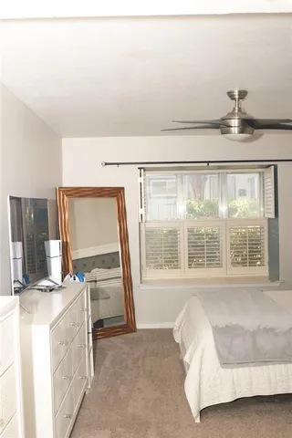 a living room with a bed furniture and fireplace