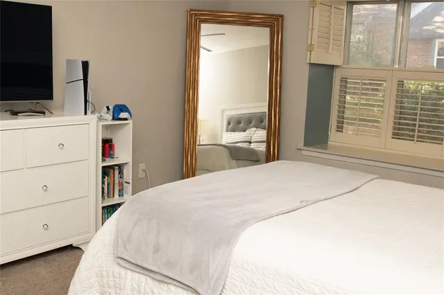 a bedroom with a bed and a flat tv screen in it