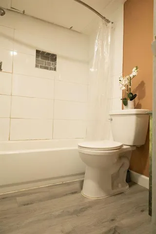 a bathroom with a toilet and a shower