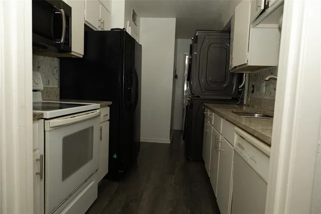 a kitchen with a refrigerator stove and cabinets