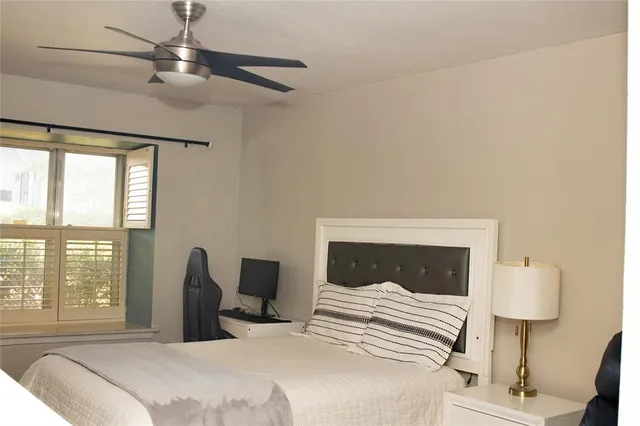 a bedroom with a bed and a lamp