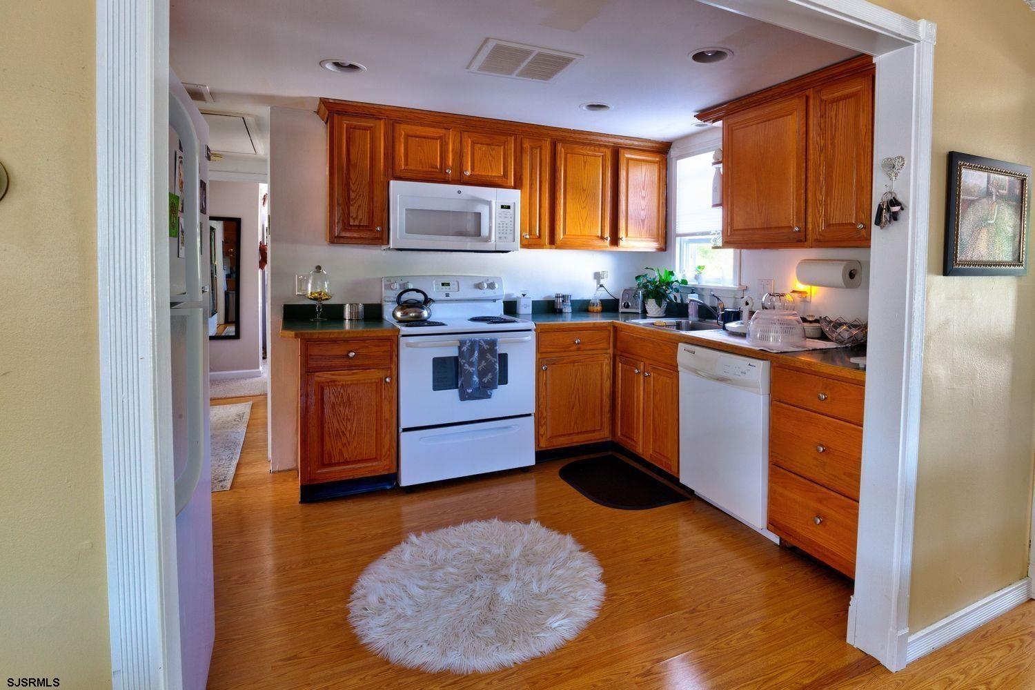 a kitchen with stainless steel appliances granite countertop a stove a refrigerator and a sink