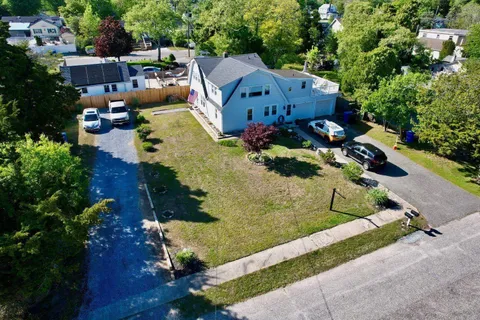 an aerial view of a house with a yard