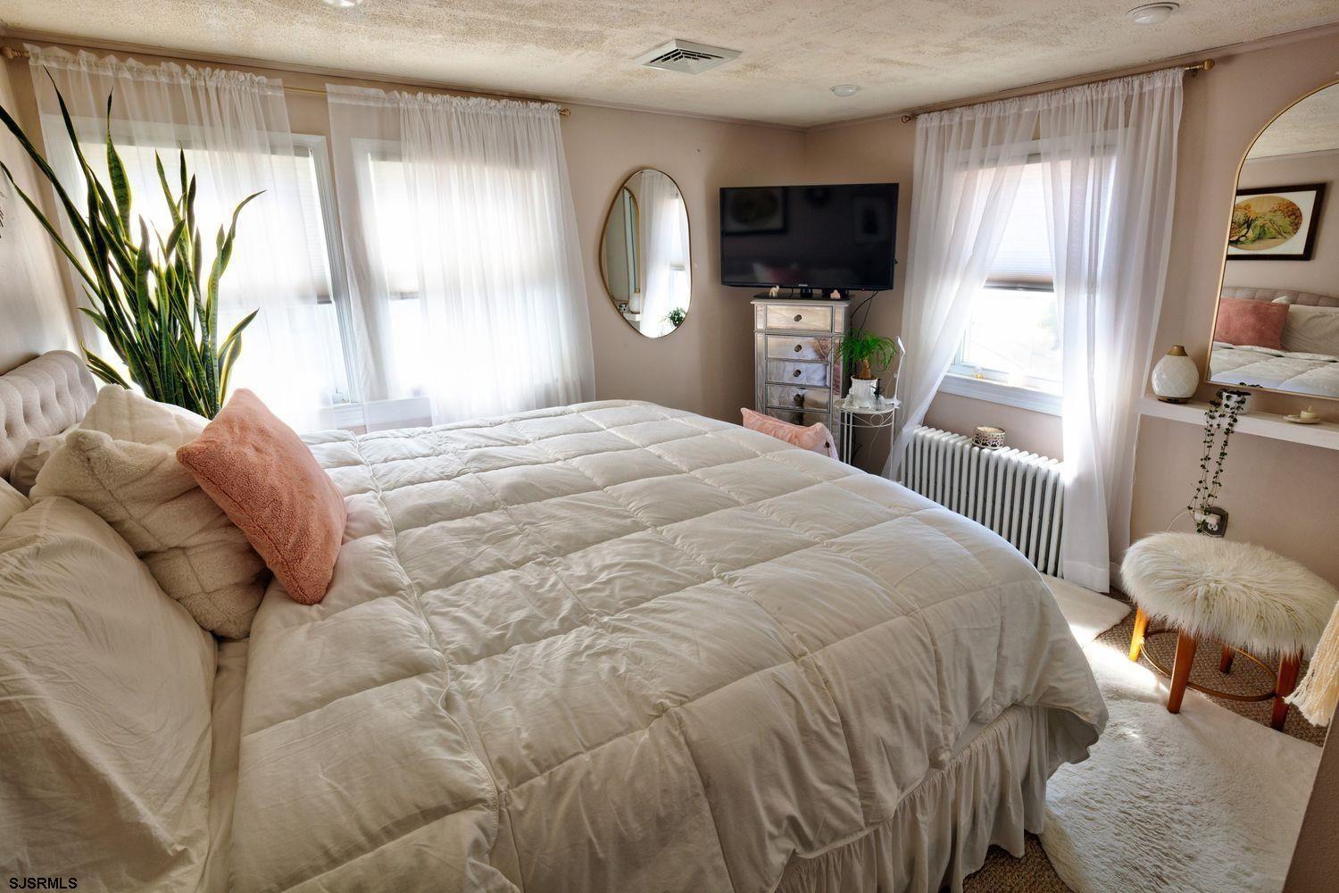14 Lyndhurst Road Marmora, NJ 08223 - Photo 16 of 35 a bedroom with a bed and a large window