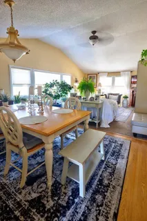a room with pool table and windows